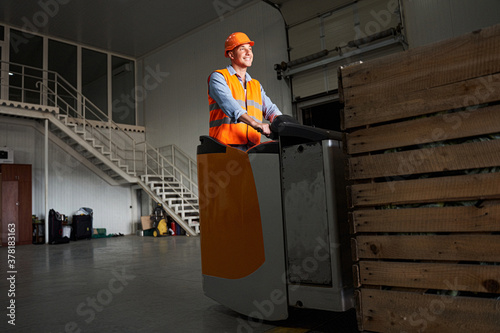 Handsome forklift driver at warehouse photo