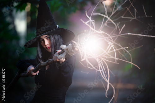 Portrait of beautiful asian sexy woman wear black witch costume with broom,Halloween festival concept