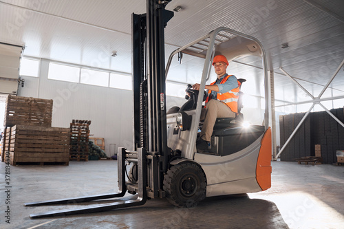 Forklift operator in warehouse