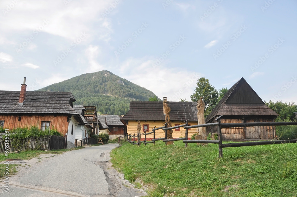 VLKOLINEC, SLOVAKIA, EUROPE, SUMMER. Views of the beautiful and touristic town of Vlkolinec, it is a Unesco Heritage. It is surrounded by mountains. At the main entrance there are some wooden figures VLKOLINEC, SLOVAKIA, EUROPE, SUMMER. Views of the beautiful and touristic town of Vlkolinec, it is a Unesco Heritage. It is surrounded by mountains. At the main entrance there are some wooden figures