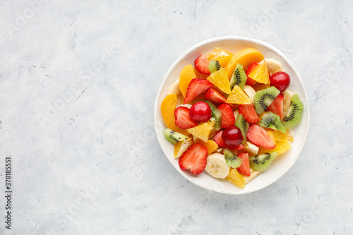 Fresh chopped fruit salad in a bowl. Top view.