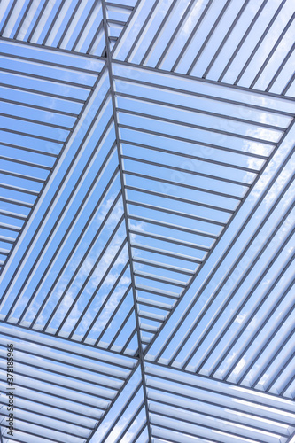 triangle pattern of a building metal lines against blue sky background