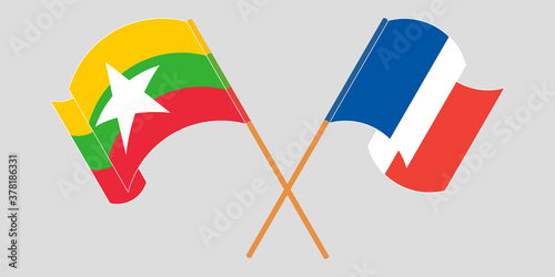 Crossed and waving flags of Myanmar and France