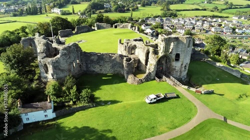 Ancient British landmark Denbigh Castle medieval old hill monument ruin tourist attraction aerial rising forward view photo