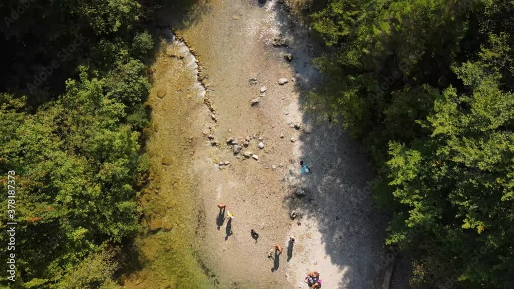 Small green river in the middle of the forrest. Small river rapids with greenish tones. People and their shaddows.
// Top down drone shot. Small green river in the middle of the forrest. Small river rapids with greenish tones. People and their shaddows.
// Top down drone shot.