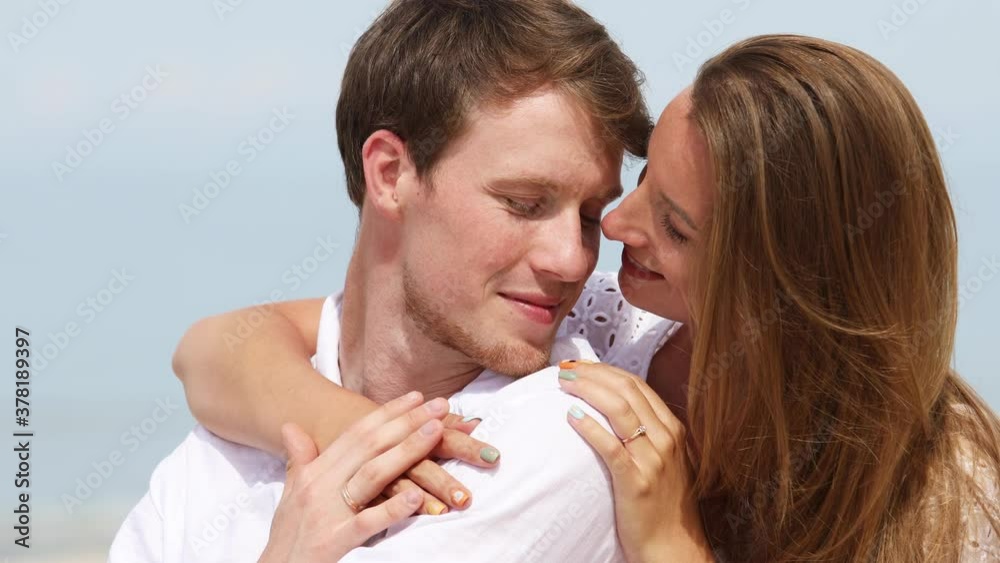 Portrait of a cute couple of young lovers resting on the beach on a sunny summer day
Portrait of a cute couple of young lovers resting on the beach on a sunny summer day