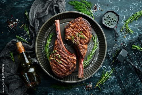 Картината върху платно Juicy steak grilled on the bone with spices and herbs