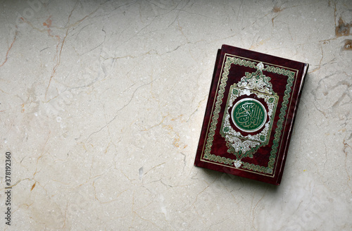 Islamic Book Koran (or Quran) on marble table photo