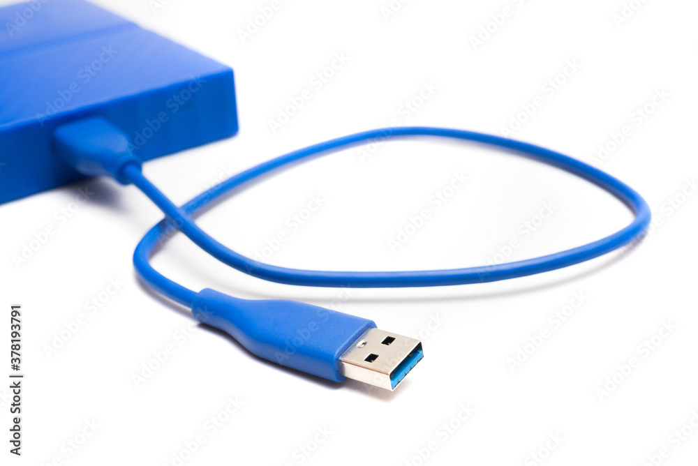 Blue external hard drive 2 terabytes with usb 3.0 port and micro-b wire for computer data storage backup isolated on white background. Blue external hard drive 2 terabytes with usb 3.0 port and micro-b wire for computer data storage backup isolated on white background.