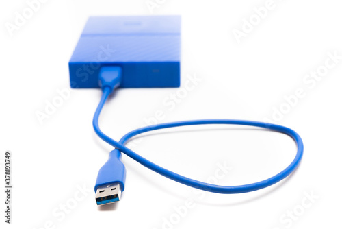 Blue external hard drive 2 terabytes with usb 3.0 port and micro-b wire for computer data storage backup isolated on white background.