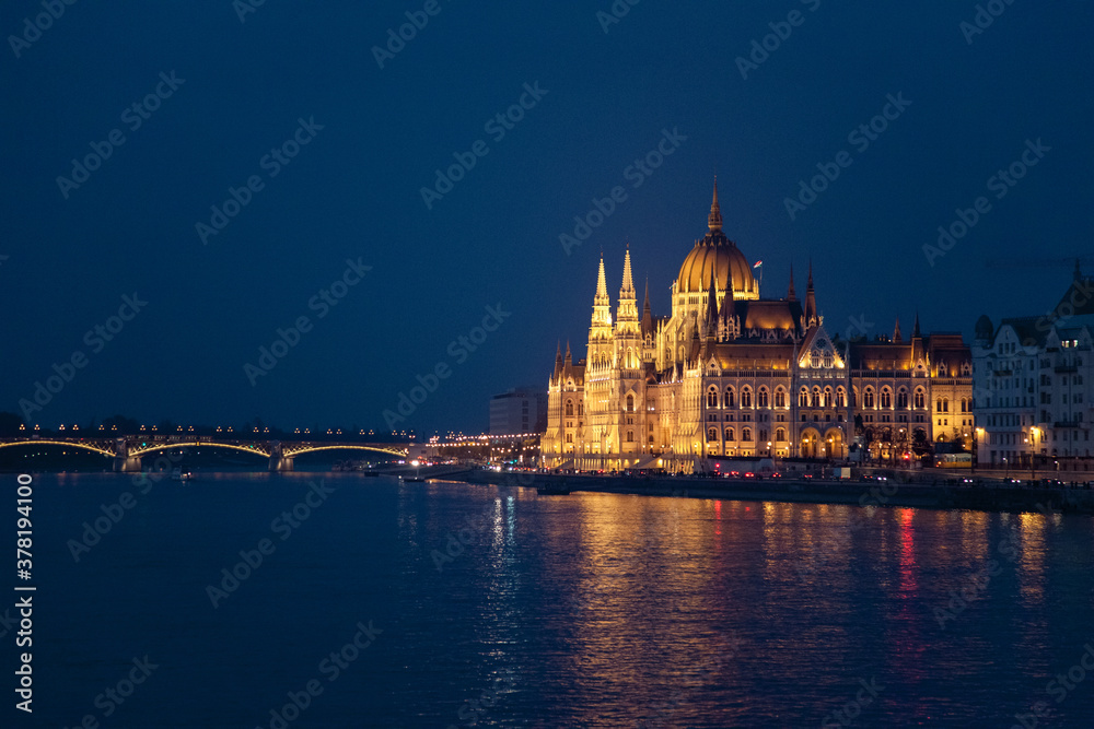 Hungarian Parliament and bridge in Budapest. Night illumination at blue background. Amazing landmark in Europe, Hungary.