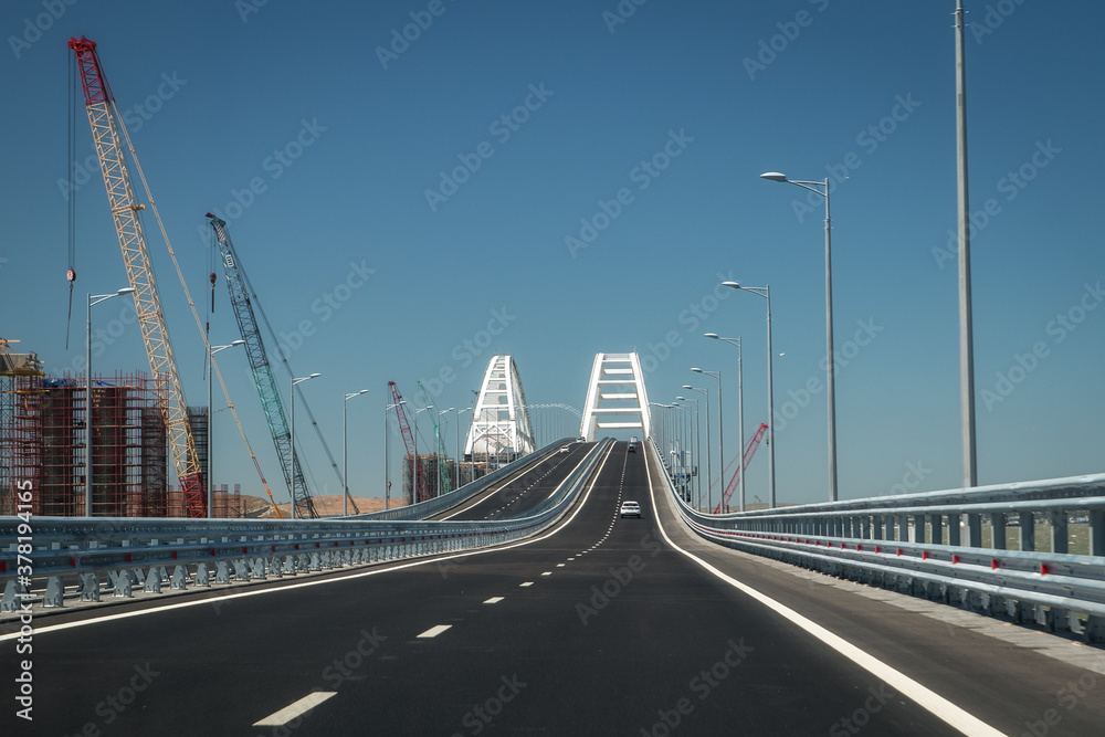 Fototapeta premium Cars go on the Crimean automobile bridge connecting the banks of the Kerch Strait: Taman and Kerch, Crimea. Russia