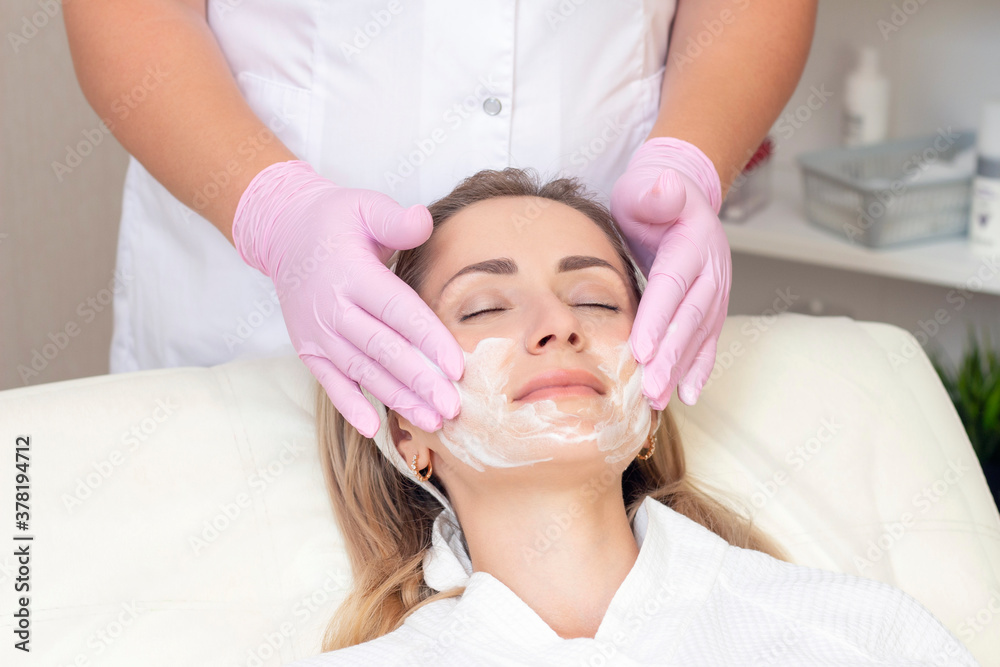 cosmetology. Close up picture of lovely young woman with closed eyes receiving facial cleansing procedure in beauty salon. cosmetology. Close up picture of lovely young woman with closed eyes receiving facial cleansing procedure in beauty salon.