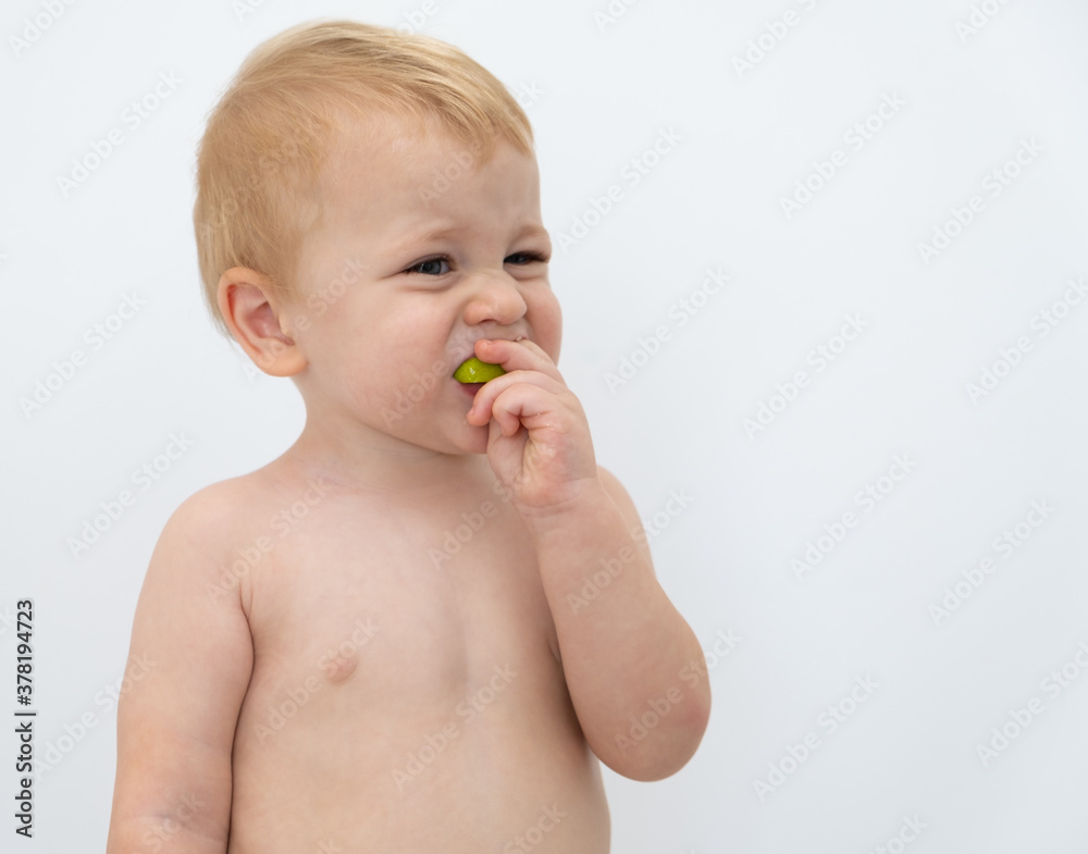 Baby boy trying and tasting new food. Dieting, vegetarian and healthy nutrition concept. Baby boy trying and tasting new food. Dieting, vegetarian and healthy nutrition concept.