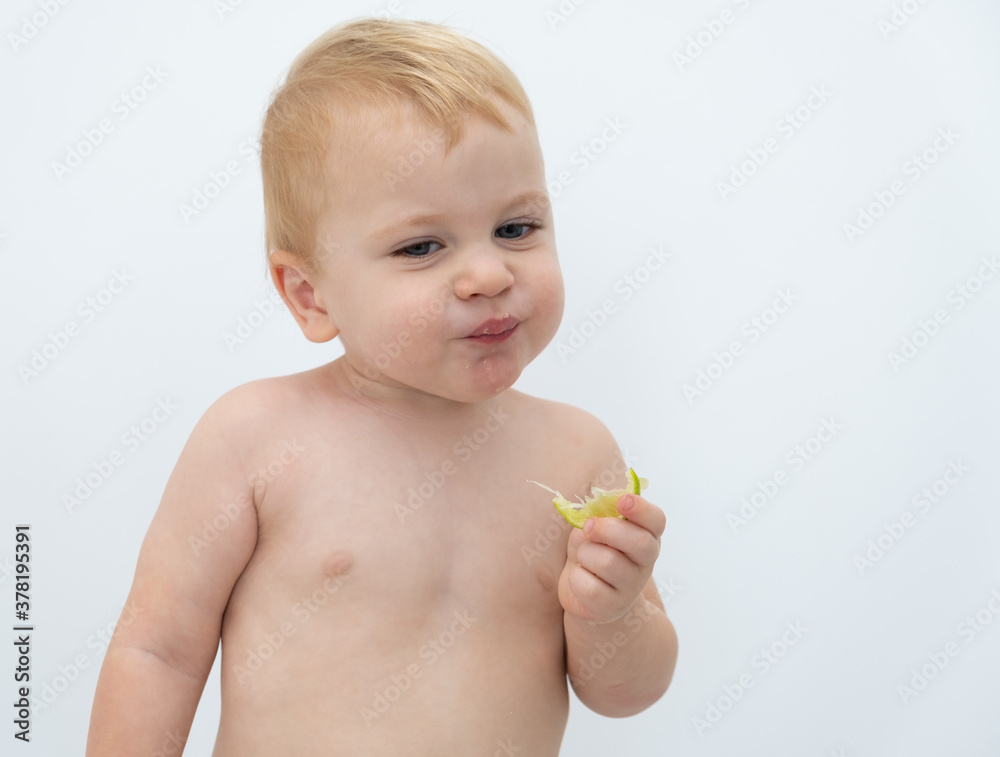 Baby boy trying and tasting new food. Dieting, vegetarian and healthy nutrition concept. Baby boy trying and tasting new food. Dieting, vegetarian and healthy nutrition concept.