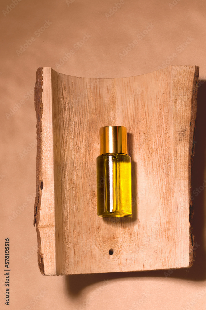 Cosmetic natural oil on wood. Beige background. View from above Cosmetic natural oil on wood. Beige background. View from above