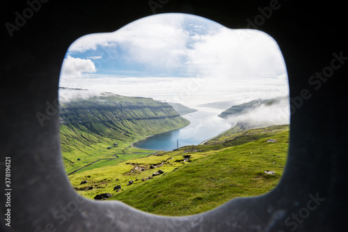 Ausblick auf die Fjord-Landschaft der Färöer Inseln bei schönem Sommerwetter.  photo