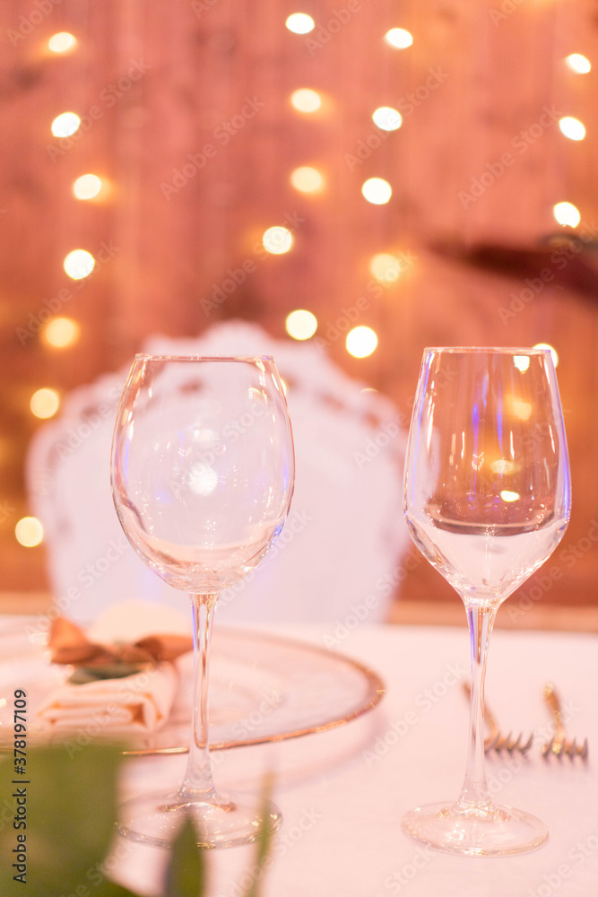 glasses on the festive table in the evening lights