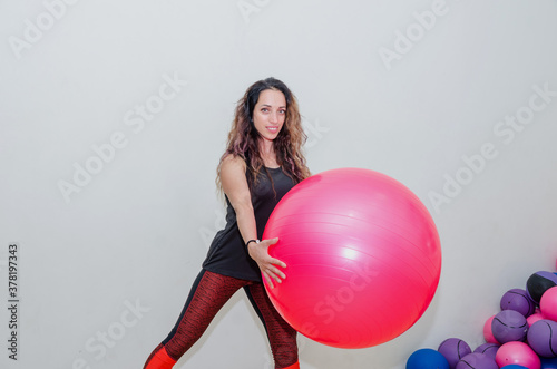 sport, training and lifestyle concept - beautiful woman with fitness ball in the gym. © Tania