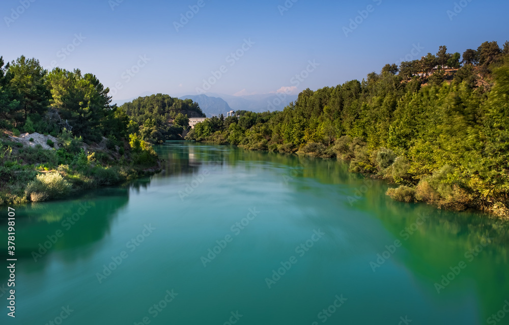 Manavgat river, view on the backgropund. Beautiful river landscape. July 2020. Long exposure picture