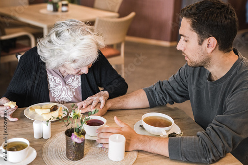 Wallpaper Mural Old woman having afternoon tea with her grandson Torontodigital.ca