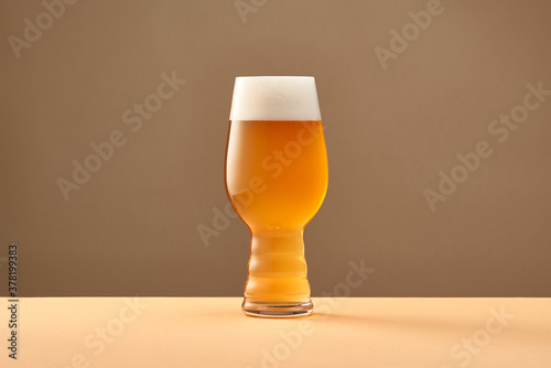 Cup with cold beer on table