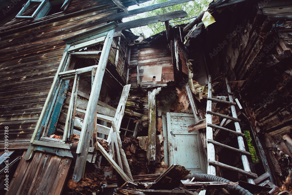 Destroyed wooden house in the woods.