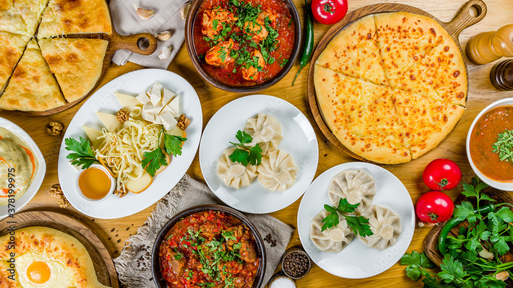 Georgian cuisine foodset from khachapuri, khinkali, pkhali, dolma, satsivi, chahohbili, chashushuli, top view Georgian cuisine foodset from khachapuri, khinkali, pkhali, dolma, satsivi, chahohbili, chashushuli, top view