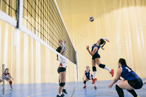 Focused female volleyball player blocking served ball while tournament in Madrid, Spain. photo