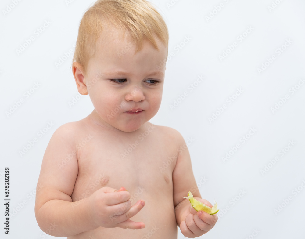 Baby boy trying and tasting new food. Dieting, vegetarian and healthy nutrition concept. Baby boy trying and tasting new food. Dieting, vegetarian and healthy nutrition concept.