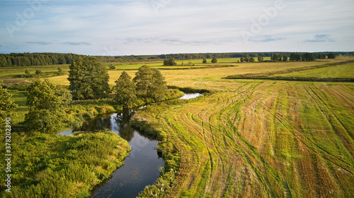 Obraz na płótnie Autumn landscape in evening sunlight from above. Agriculture fields after harvest w salonie