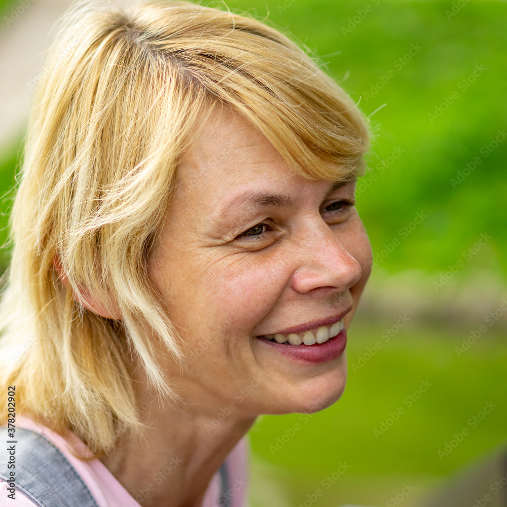 Cheerful Mature woman resting in a Park Cheerful Mature woman resting in a Park