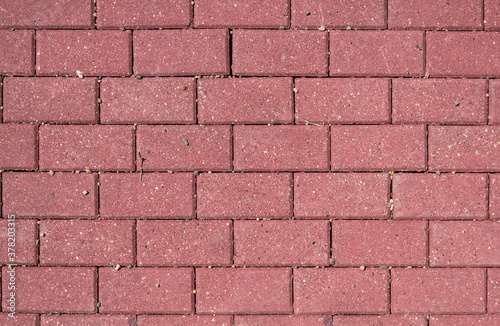 Background of red paving slabs stones, brick wall close up