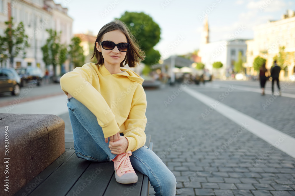 Cute young girl sightseeing on the streets of Vilnius, Lithuania on warm and sunny summer day. Cute young girl sightseeing on the streets of Vilnius, Lithuania on warm and sunny summer day.