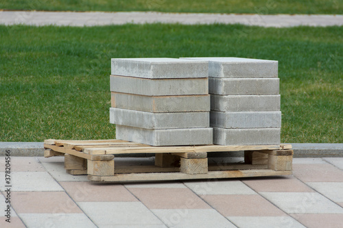 gray paving slabs laid on a large wooden pallet