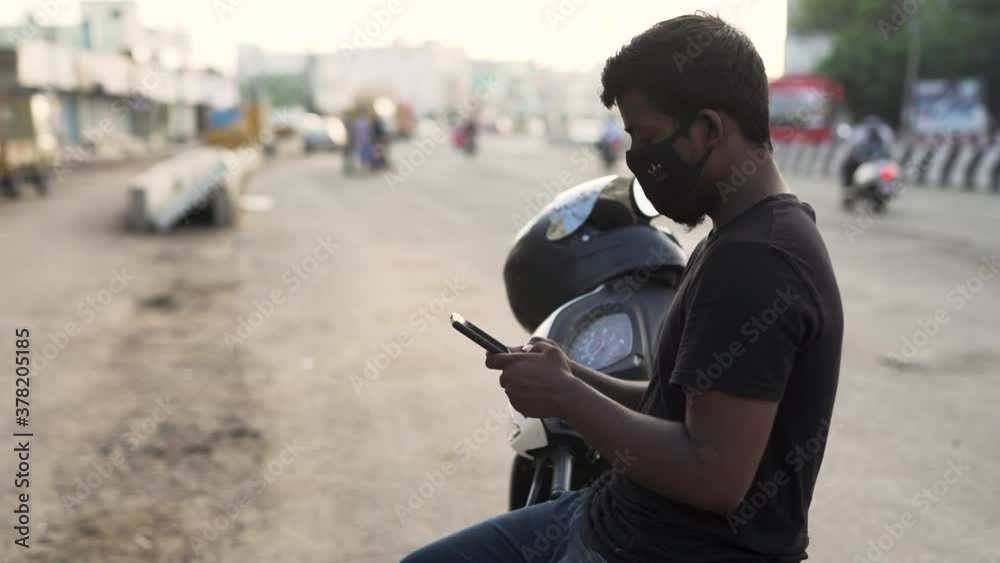 Young Indian Tamil man chatting on phone during corona pandemic in Chennai, Tamil Nadu, India Young Indian Tamil man chatting on phone during corona pandemic in Chennai, Tamil Nadu, India