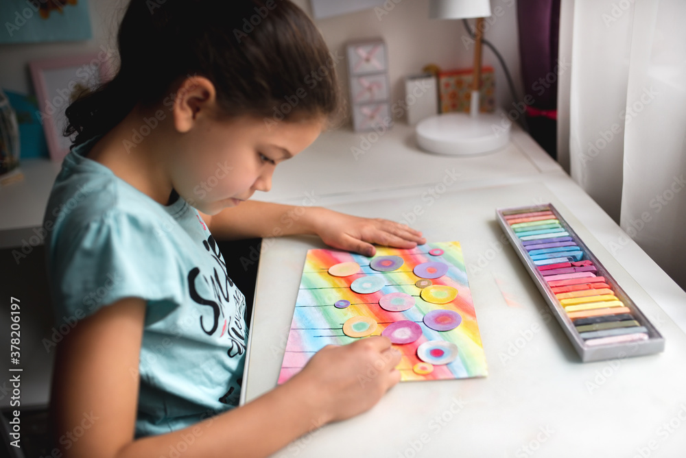 Child drawing a field of flowers with chalk pastel Child drawing a field of flowers with chalk pastel