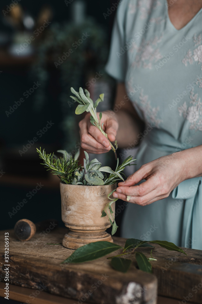 Anonymous Woman Arranging Fresh Herbs In Mortar Anonymous Woman Arranging Fresh Herbs In Mortar