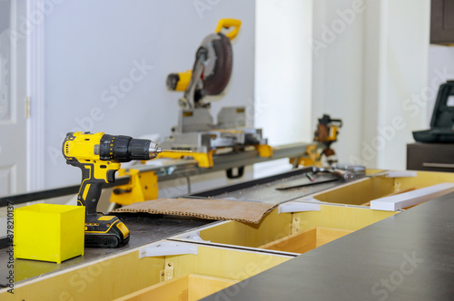 Wooden furniture production of professional instrument tools screwdriver on blurred background