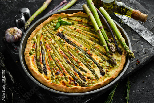 Puff pastry tart with asparagus and spices. Healthy food. Top view. Free space for your text.