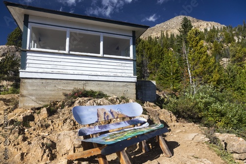 Vintage Paget Fire Lookout Building Exterior with Colorful Wooden Bench made of old ski boards. Yoho National Park, Canadian Rocky Mountains photo