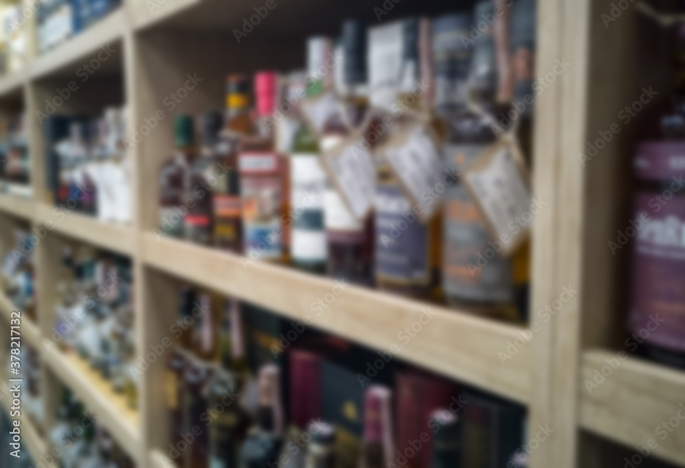 Blurred abstract background of shelf in supermarket. Alcohol showcase blurred background.