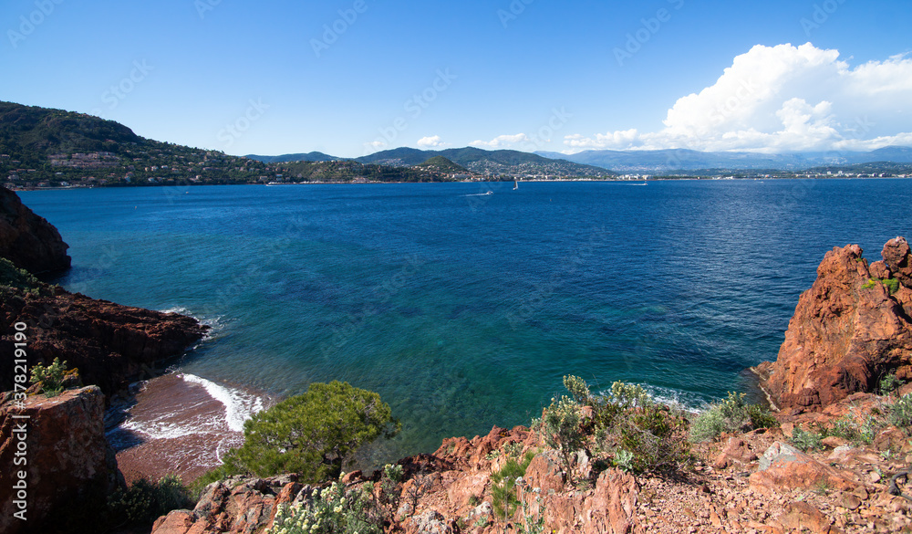 Blue mediterranean sea and red cliff during spring in Mandelieu, France