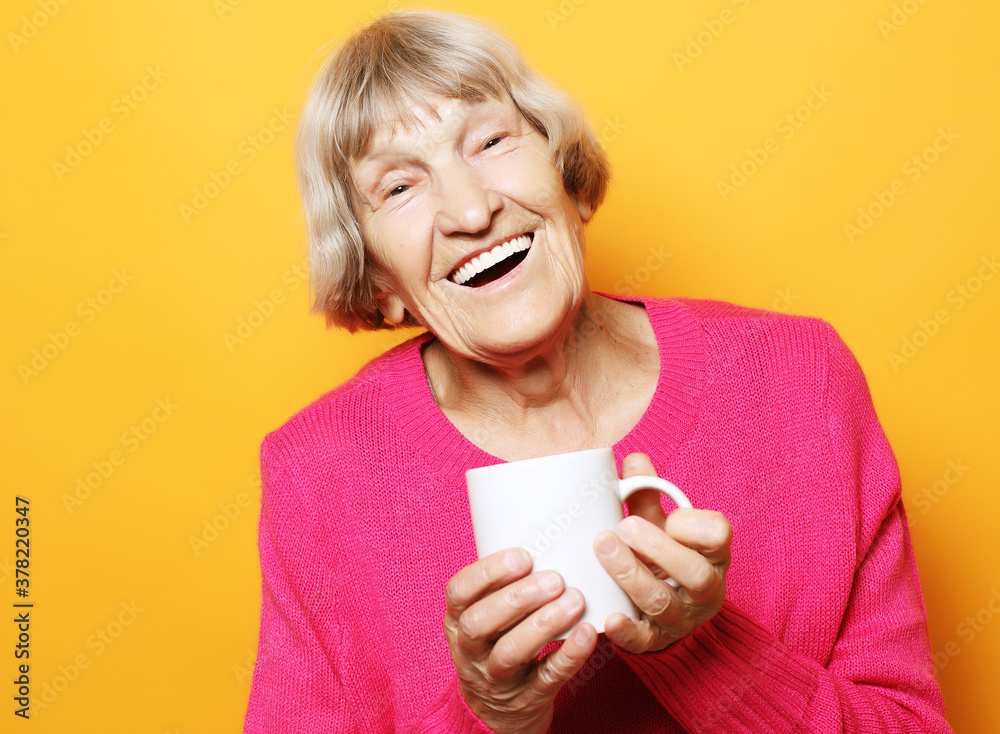 Portrait of old excited lady smiling laughing, holding cup drinking coffee, tea Portrait of old excited lady smiling laughing, holding cup drinking coffee, tea