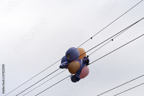 balloons entangled in electrical wires in the city photo