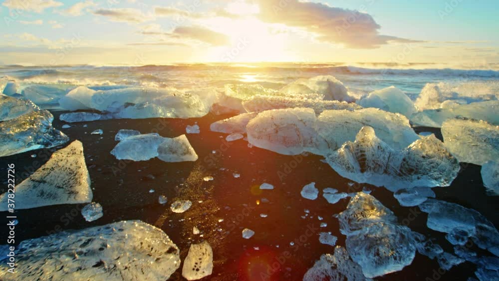 Ice on Okulsarlon Beach at sunset, slow motion close up