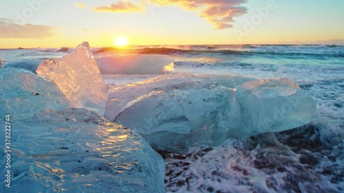Close up, bits of ice on Okulsarlon Beach at sunset