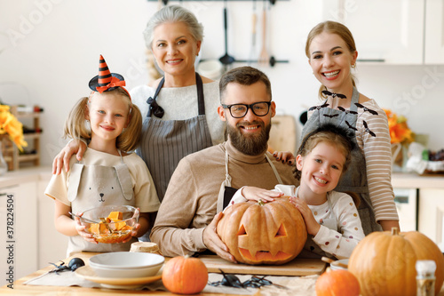 Happy multi generational family preparing for Halloween celebration.