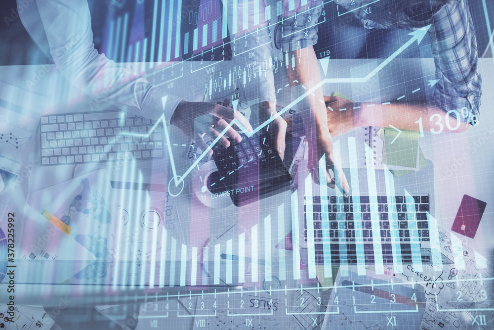Multi exposure of man and woman working together and forex graph hologram drawing. Financial analysis concept. Computer background. Top View. Multi exposure of man and woman working together and forex graph hologram drawing. Financial analysis concept. Computer background. Top View.