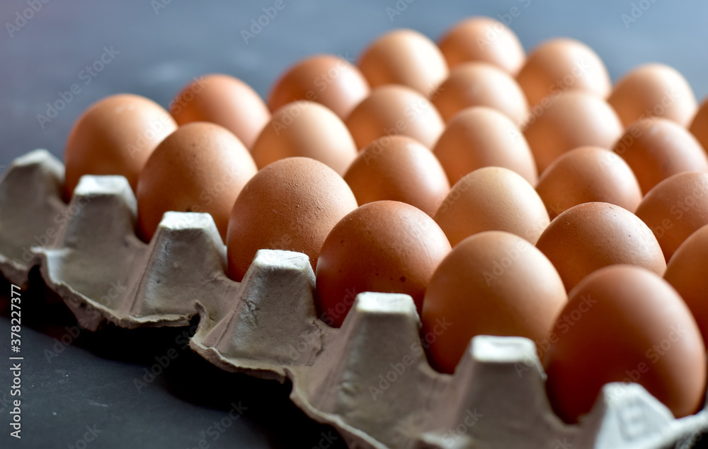 Close up Raw Brown Chicken Eggs, Easter eggs In Paper Container, selective focus points. Close up Raw Brown Chicken Eggs, Easter eggs In Paper Container, selective focus points.